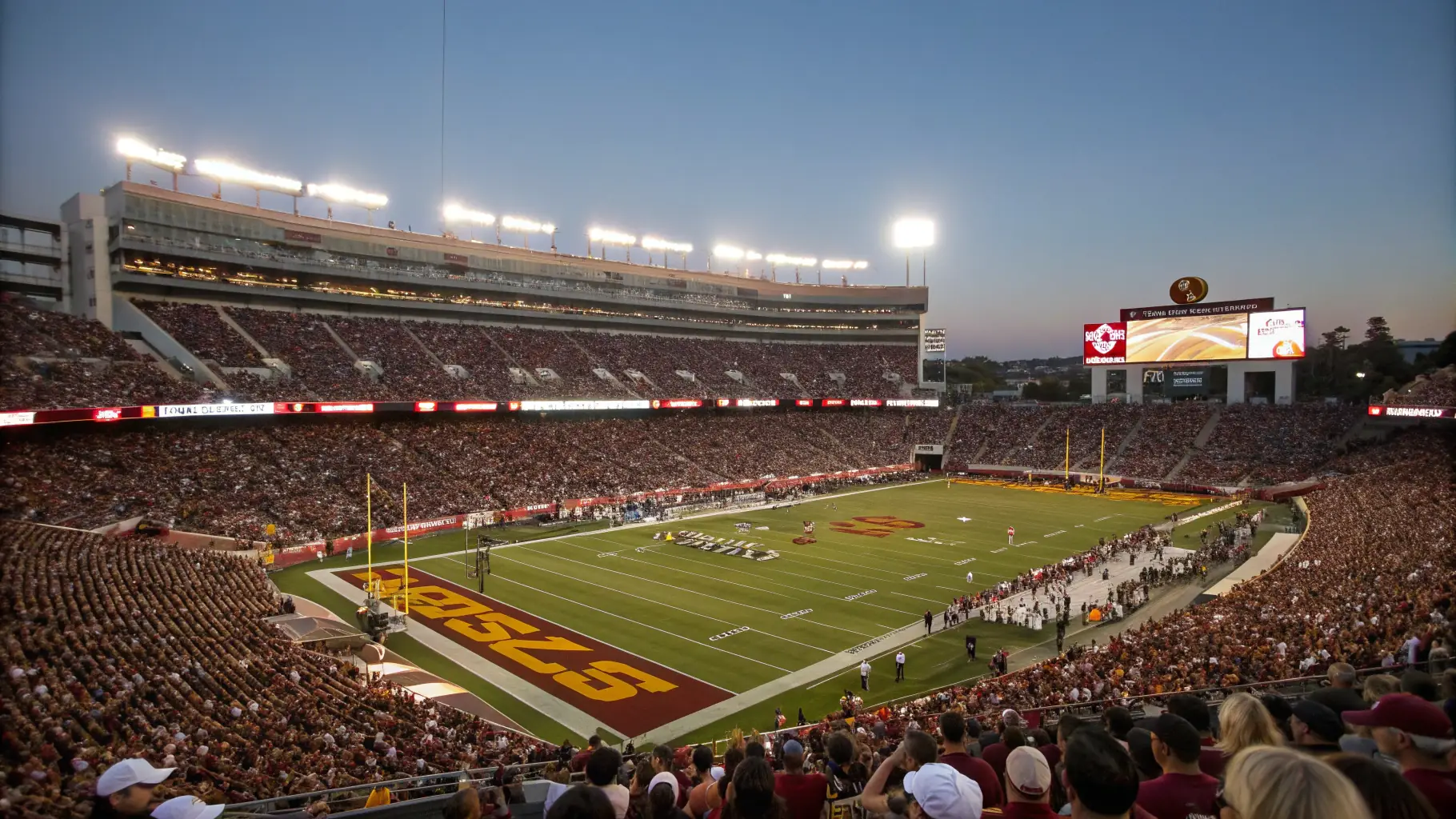 A photograph of Rodez Aveyron Football stadium during a match, with fans cheering in the background.